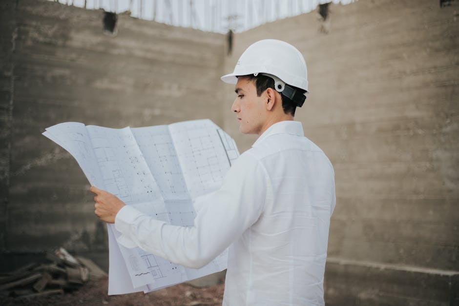 General contractor reviewing blueprints on site